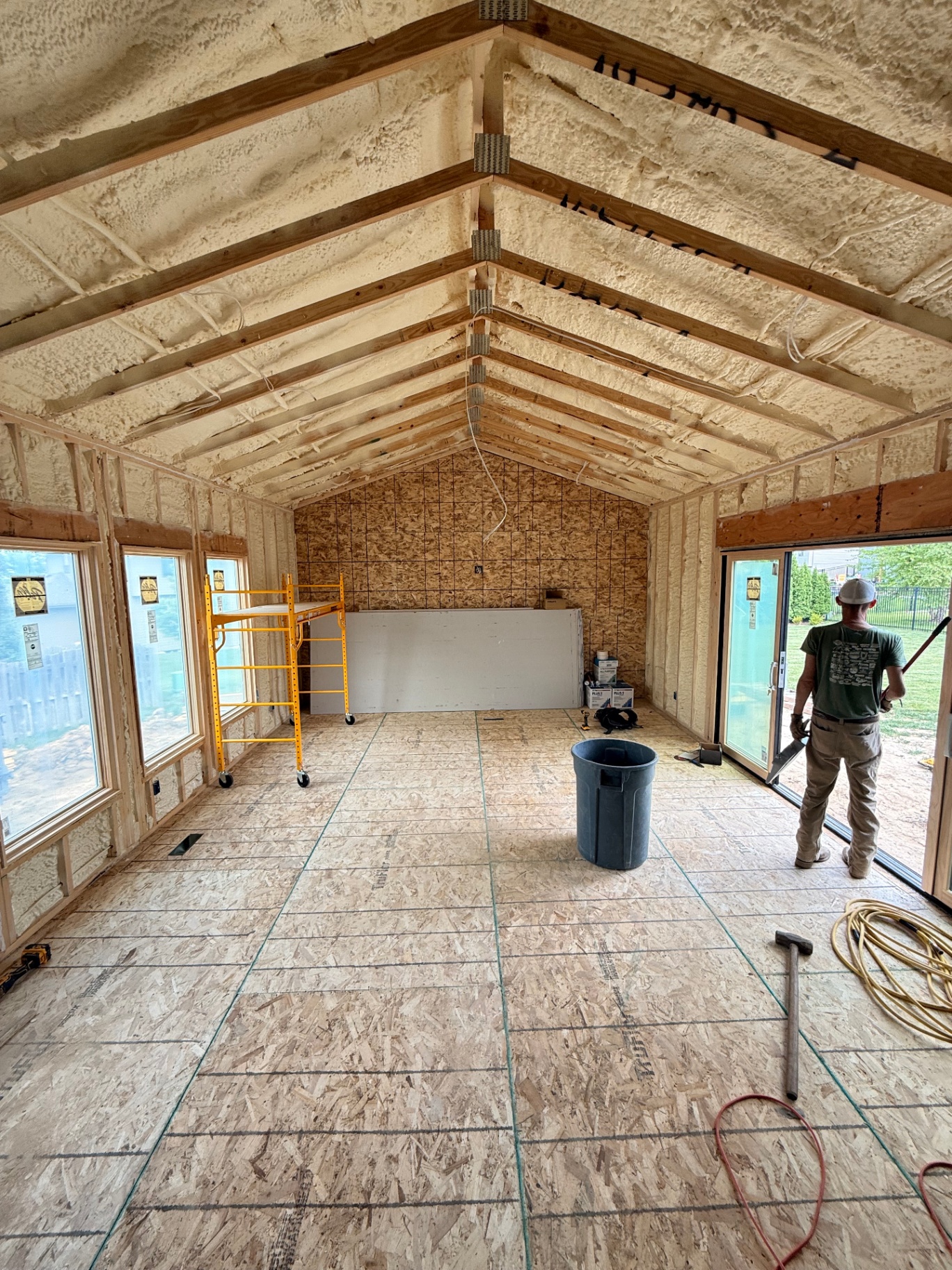 Insulated vaulted addition prepped and staged — board on site, scaffold set, ready to start hanging