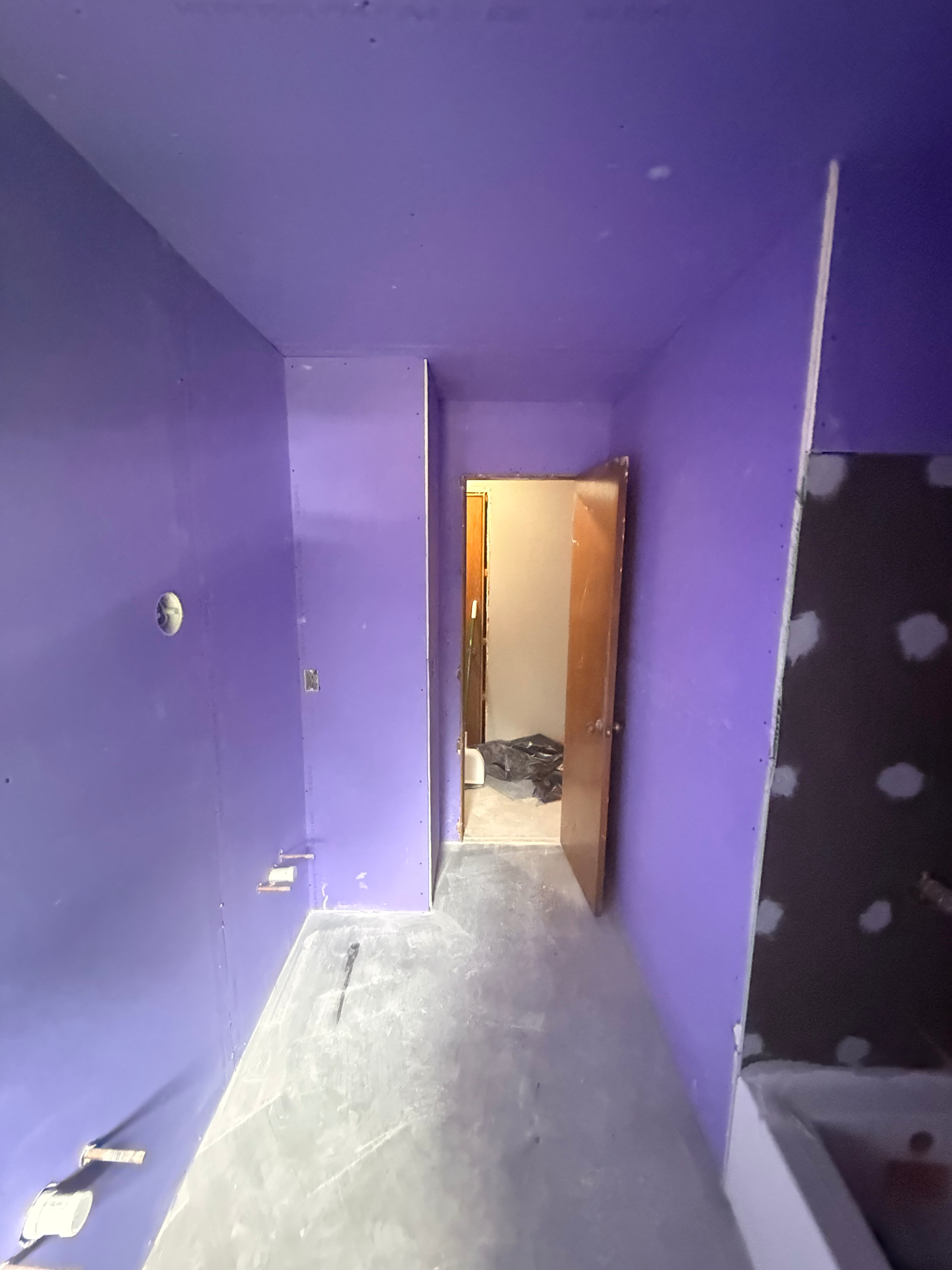 Tighter angle on the doorway side showing clean board layout and moisture-resistant coverage around the shower entry