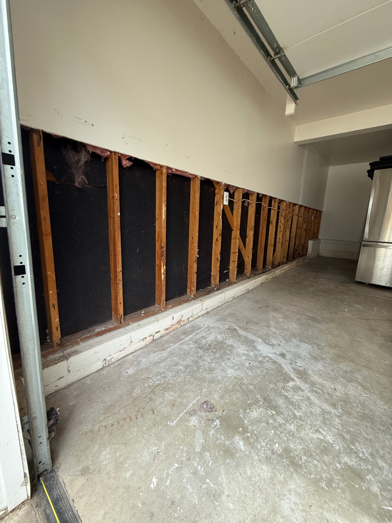 Framing exposed across the full wall span so damaged material at the base could be evaluated before rebuilding