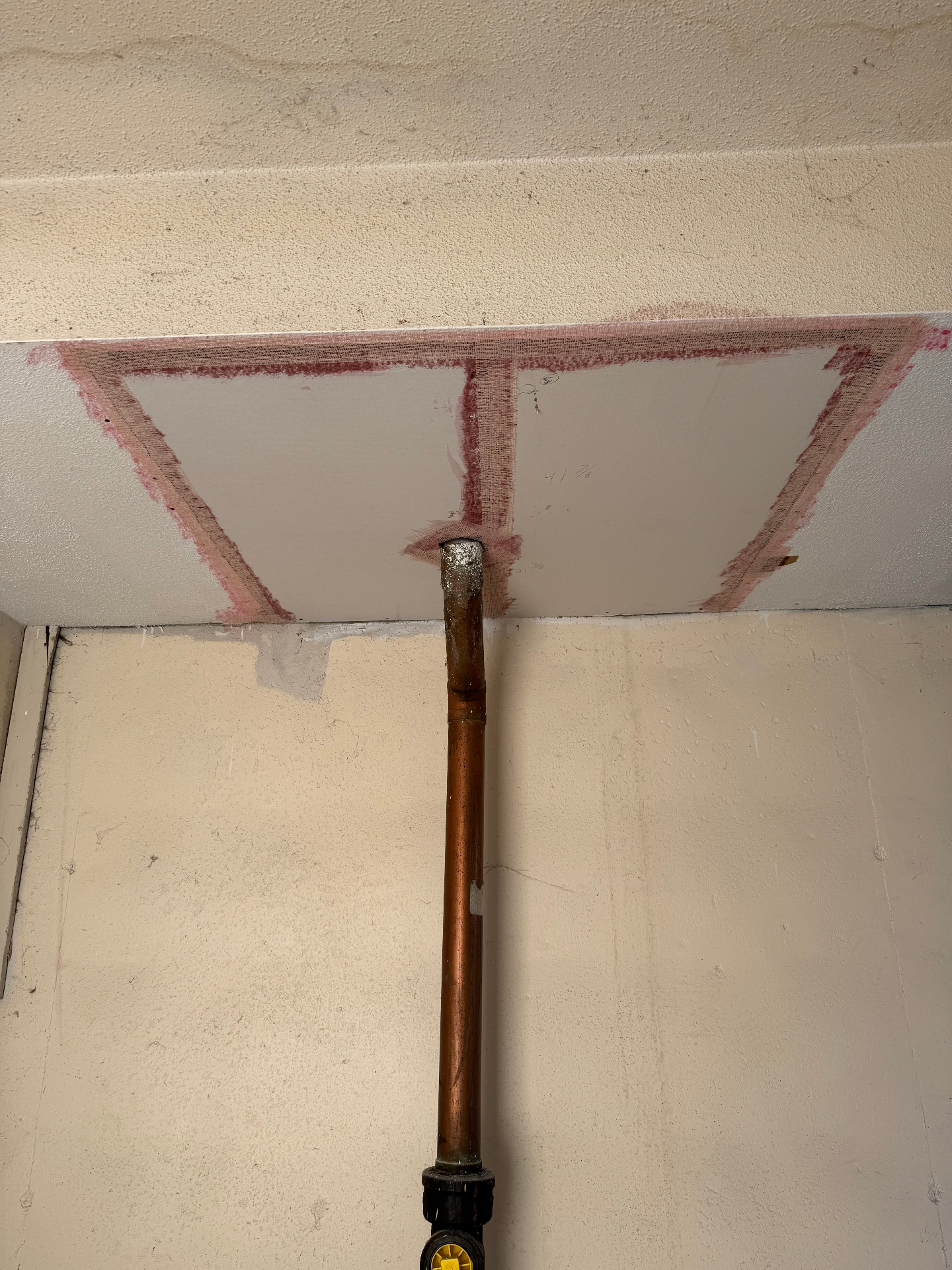Patch taped and reinforced around the full opening with mesh and compound to bridge the repair into the original ceiling
