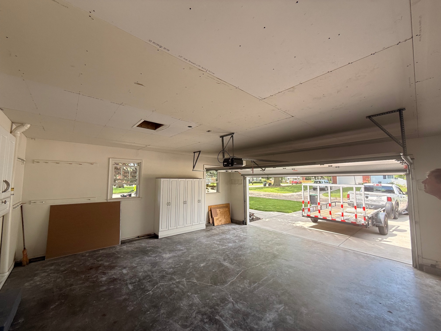 Garage prepped before overlay — original ceiling cleared and ready for new drywall to go up
