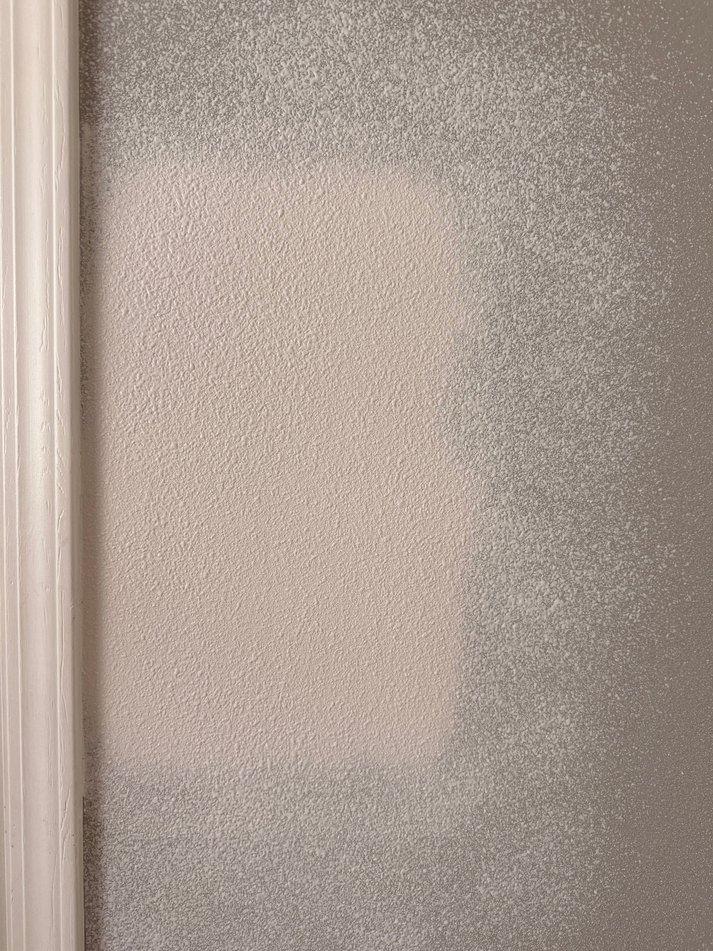 Fresh orange peel texture sprayed over the patch — splatter pattern dialed in to match the surrounding wall