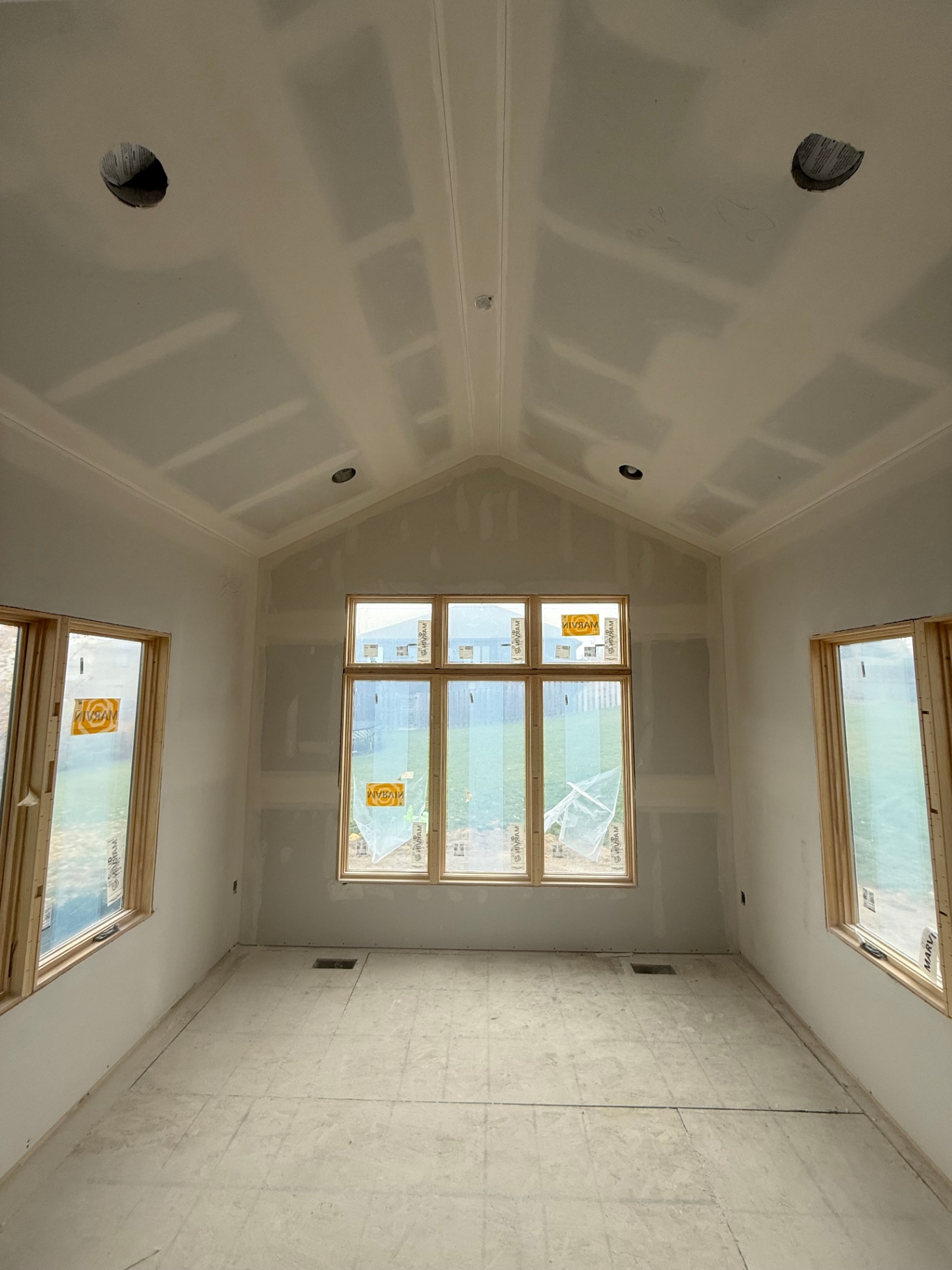 Finished addition — vaulted ceiling and walls sanded smooth with crisp corners around the windows
