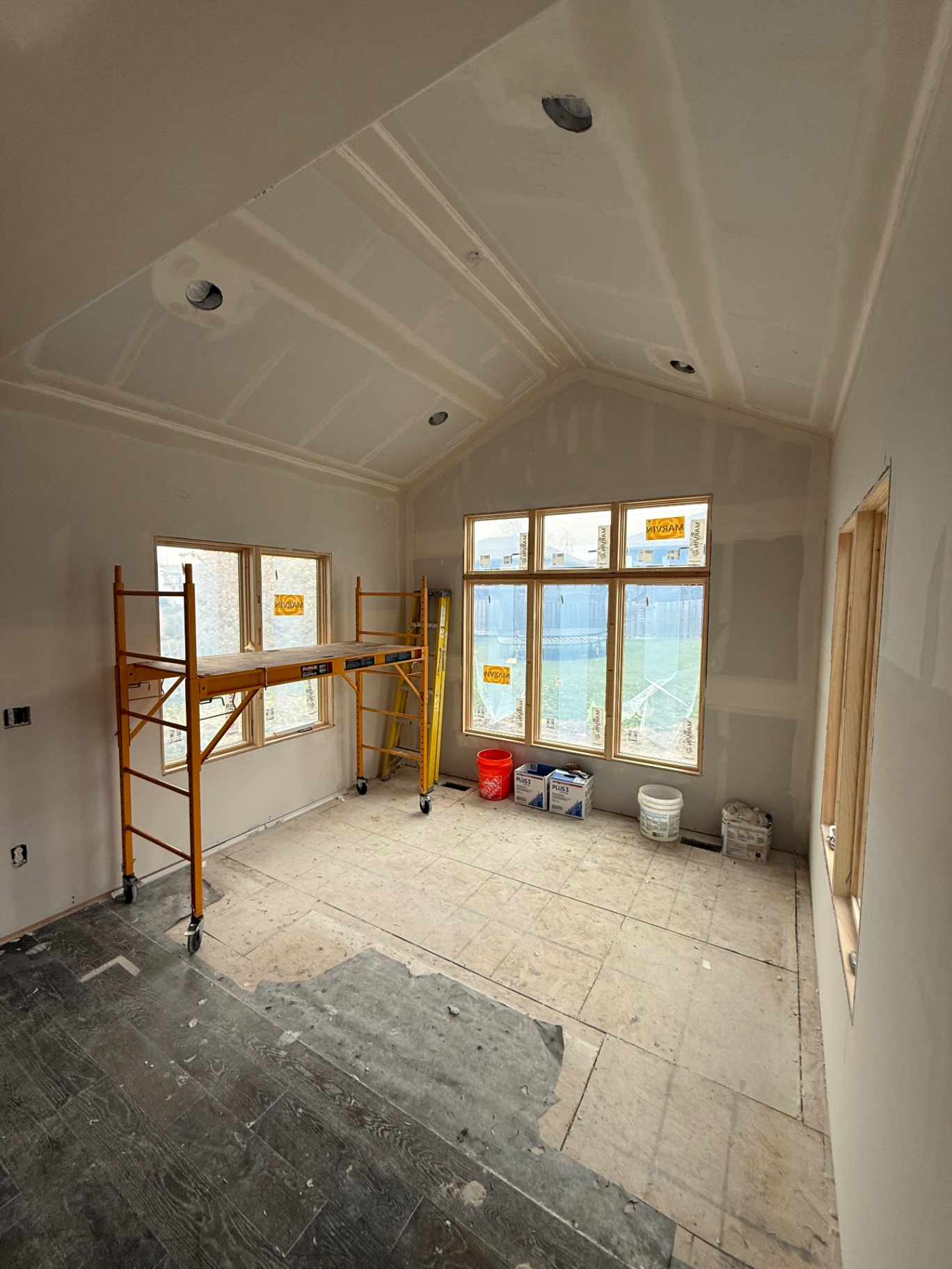 Vaulted ceiling and walls taped, mudded, and sanded — finish coats floated across every seam