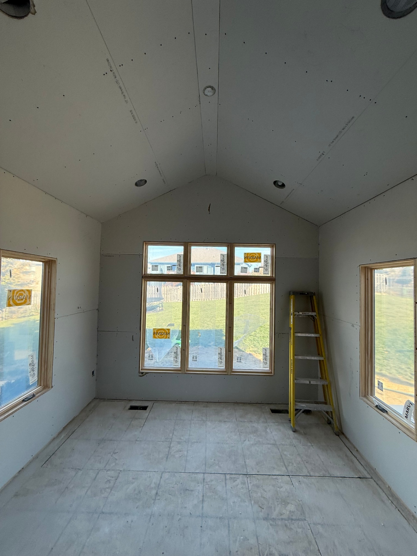 Gable-end wall and ceiling boarded around the picture window, ready for finishing