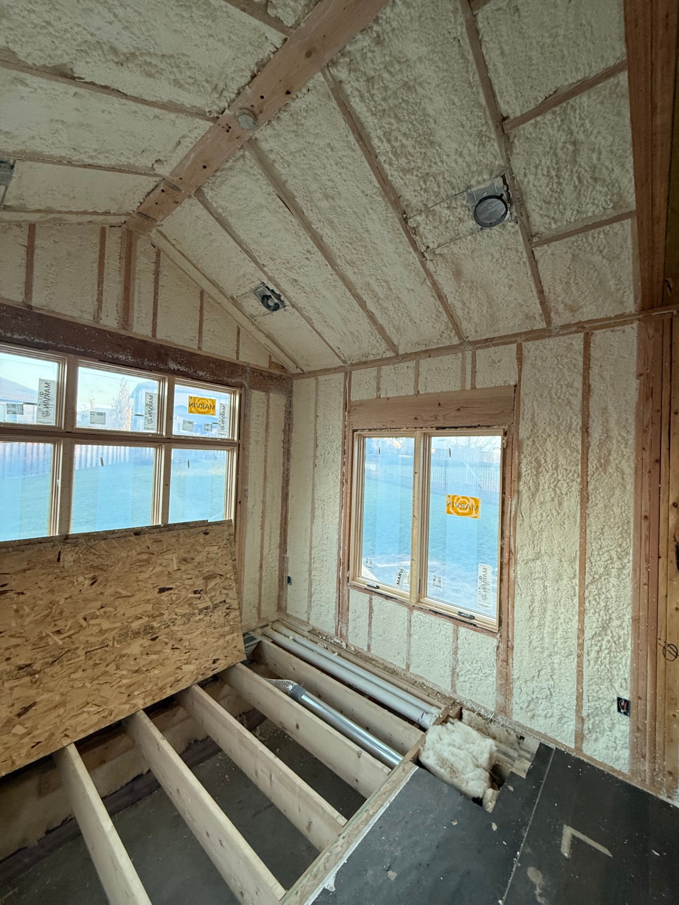 Side wall and vaulted ceiling fully insulated with closed-cell foam, ready for board