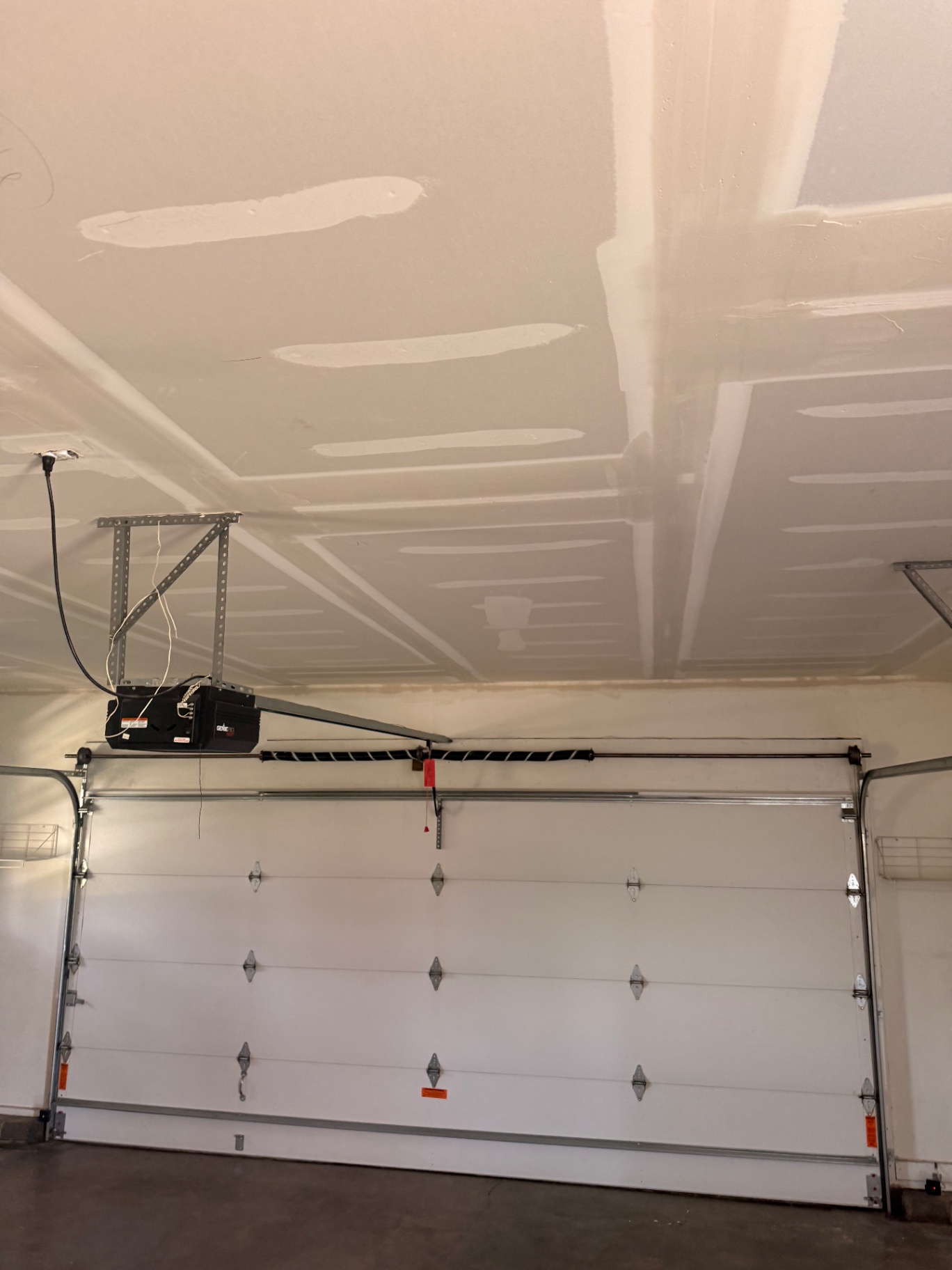 Finish coats floated across the full ceiling span — joints feathered and ready for sanding