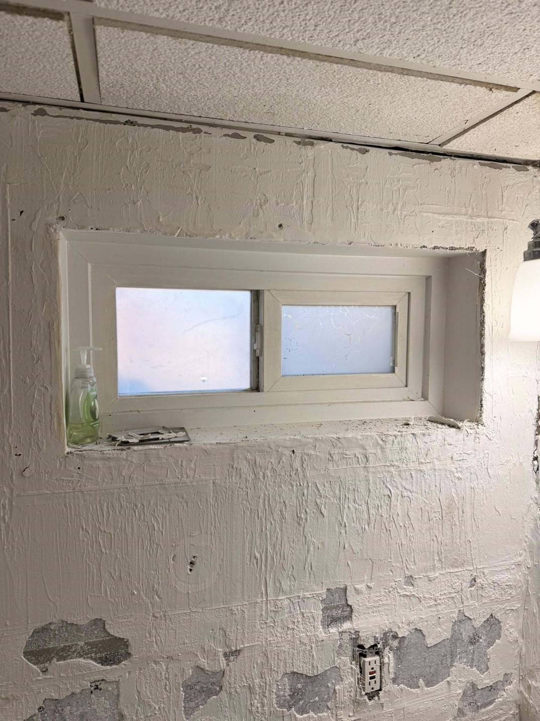 Skim-coating an old plaster bathroom wall around the window