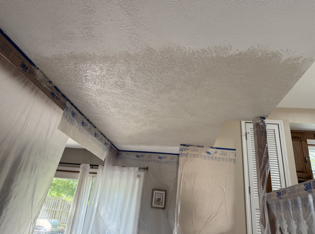 Freshly sprayed knockdown ceiling — masked off and drying