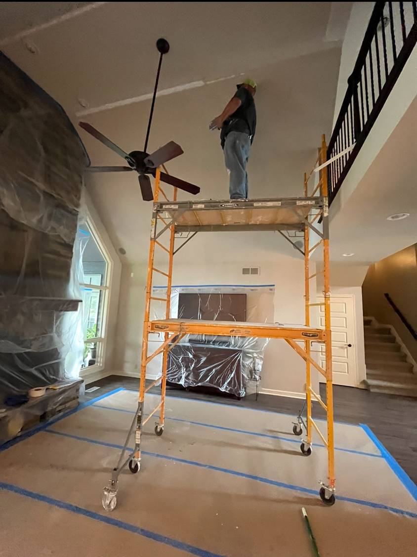 Finishing a vaulted living-room ceiling from a rolling scaffold
